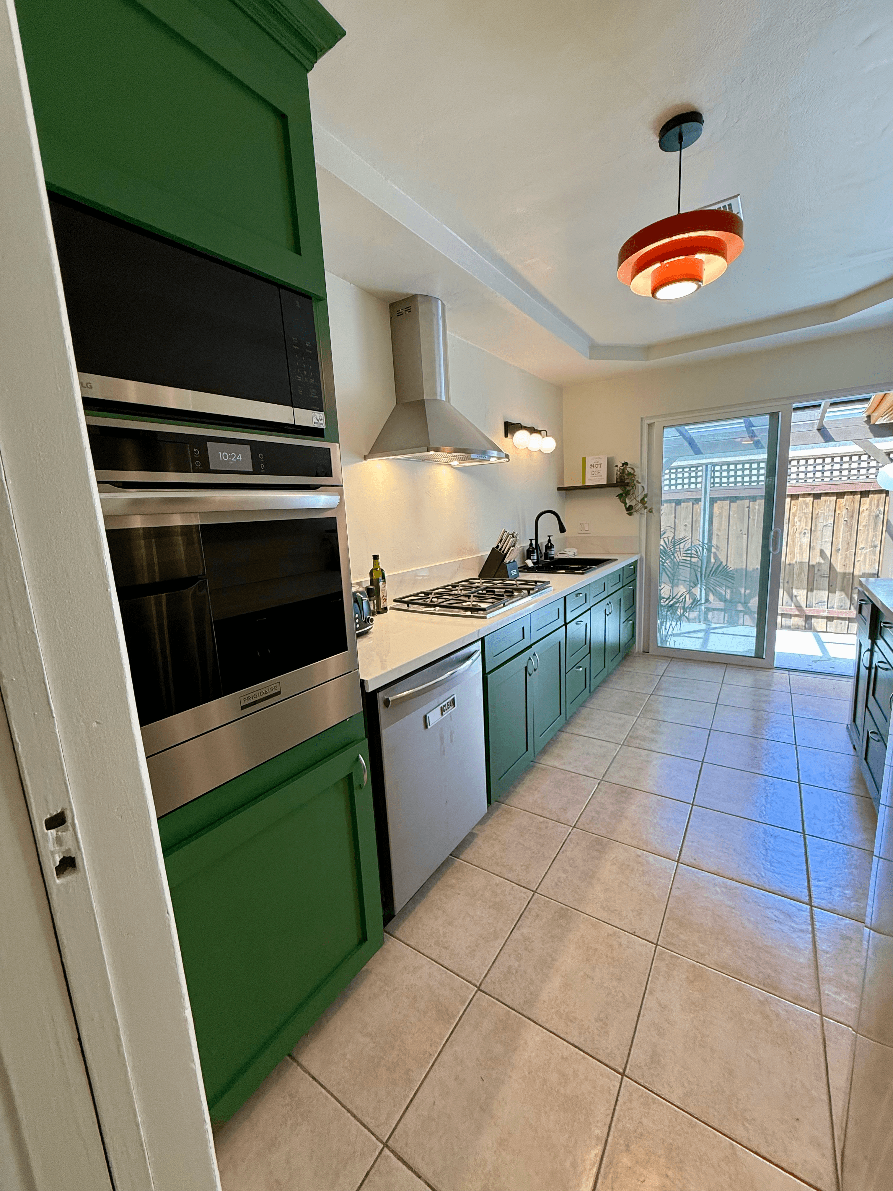 Forest green kitchen with vintage pendant lamp