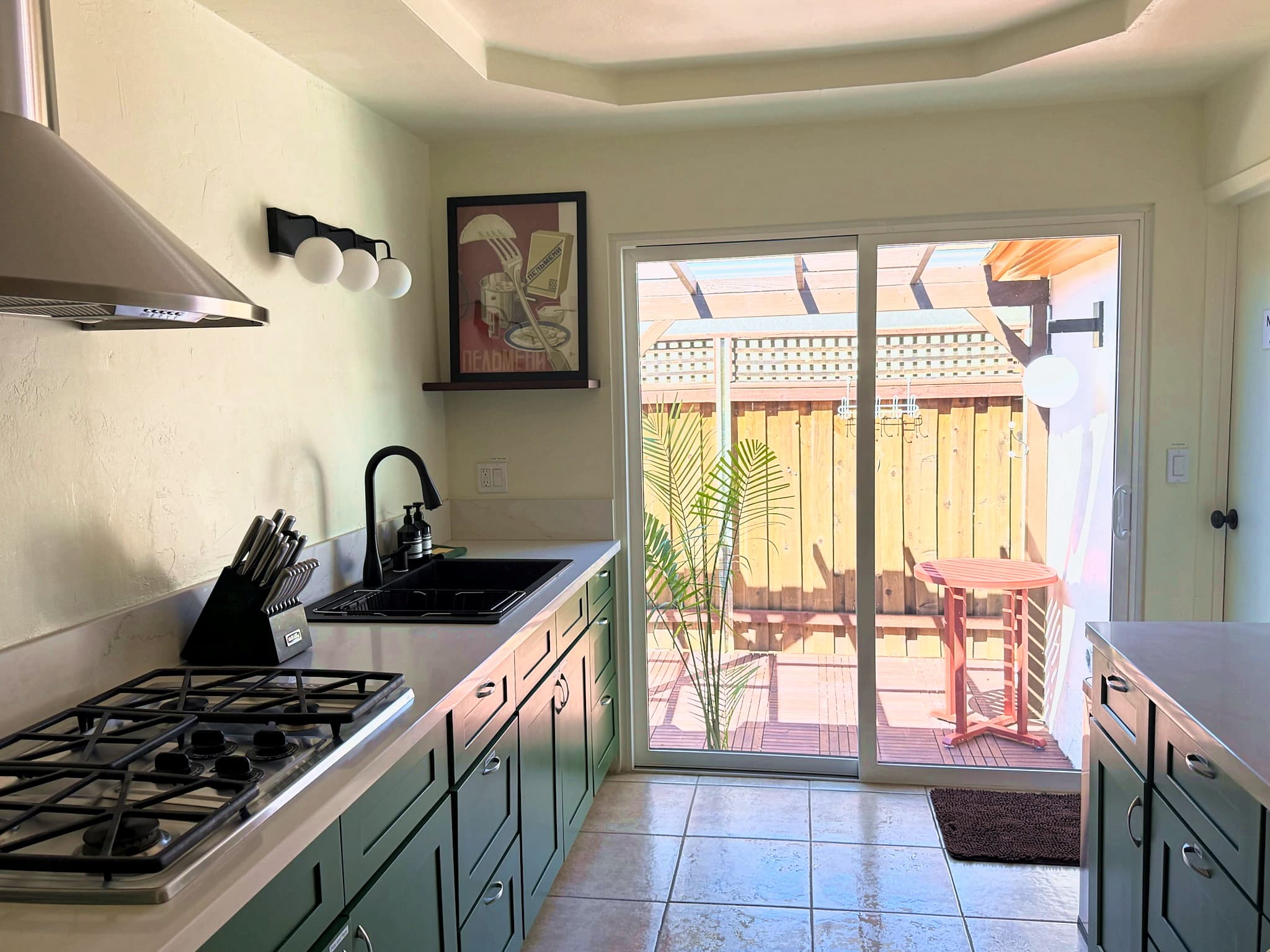 Forest green kitchen with vintage pendant lamp